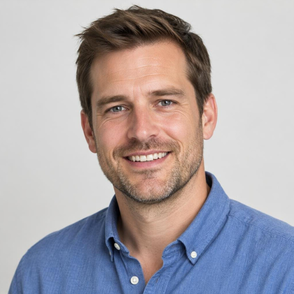 Portrait of a smiling man with short hair in a casual shirt